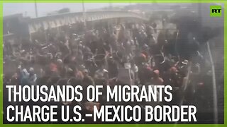 Thousands of migrants charge U.S.-Mexico border