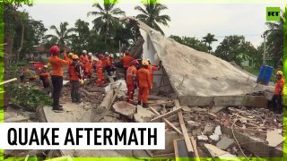 Rescuers search through rubble left by Java earthquake