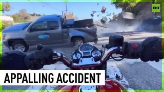 Motorcyclist hit by flying pick-up truck