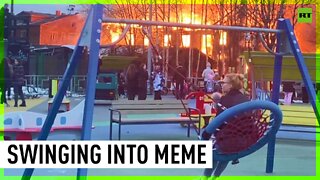 ‘0’ swings given: Woman and child on playground near burning building