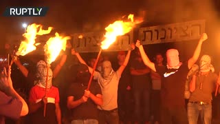 Protesters burn Star of David with swastika inside it during anti-settlement rally in West Bank