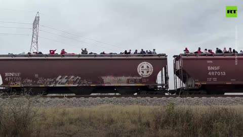 Hundreds of migrants filmed riding on top of train to US border