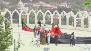 Afghans mark Independence Day by unfurling an Afghan flag